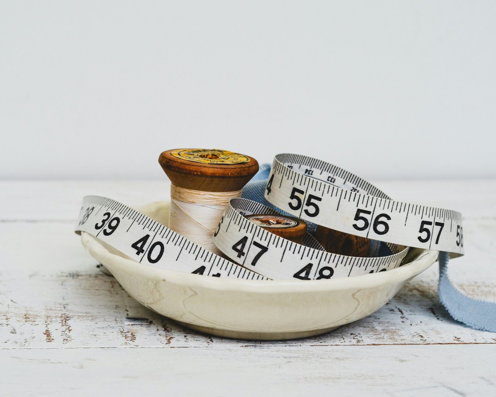A person standing on a bathroom scale, frustrated after seeing the same number despite efforts.
